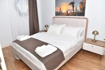 a bedroom with a large bed with white sheets and pillows at Safir Suite in Istanbul