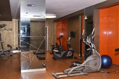 a gym with treadmills and exercise equipment in a room at Safir Suite in Istanbul