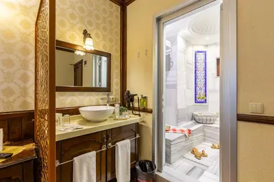a bathroom with a sink and a toilet and a mirror at Best Point Hotel Sultanahmet,Istanbul in Istanbul