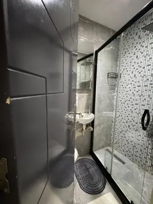 a bathroom with a shower and a sink at The Şişli No Va Park Suites in Istanbul