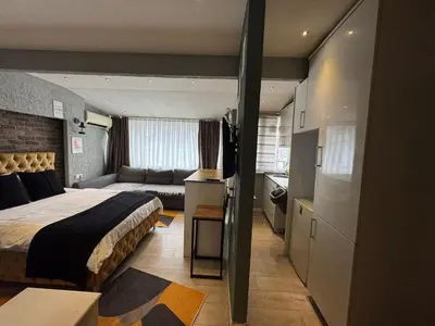 a bedroom with a bed and a couch in a room at The Şişli No Va Park Suites in Istanbul