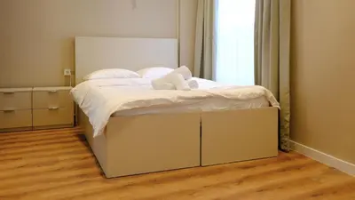 a bed in a room with a large white bed frame at Rodax Residence in Istanbul