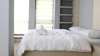 a white bed with a white stuffed animal on it at Rodax Residence in Istanbul