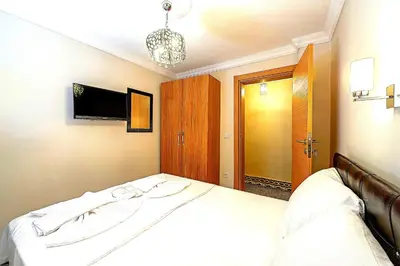 a bedroom with a bed and a tv on the wall at Efe Apart Hotel in Istanbul