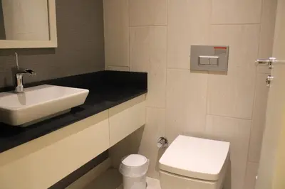 a white bathroom with a sink and a toilet at Taksim Petek Residence in Istanbul