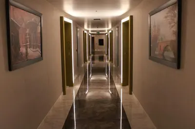 a long hallway with paintings on the walls at Taksim Petek Residence in Istanbul