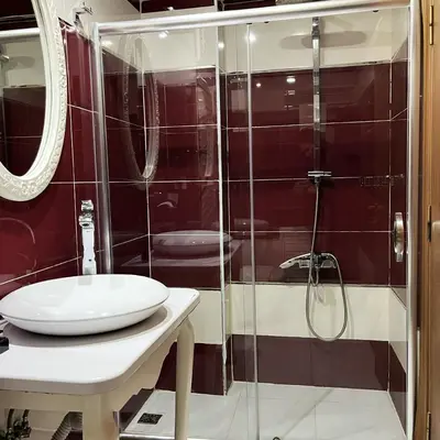 a bathroom with a glass shower and a sink at Elite Dumanlar in Istanbul