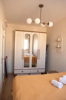 a bedroom with a bed and a dresser with a mirror at Luxe Suite AY38 in Eskiömerler