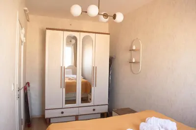 a bedroom with a dresser and a mirror at Luxe Suite AY38 in Eskiömerler
