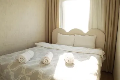 a bed with towels on it with a window at Luxe Suite AY37 in Eskiömerler