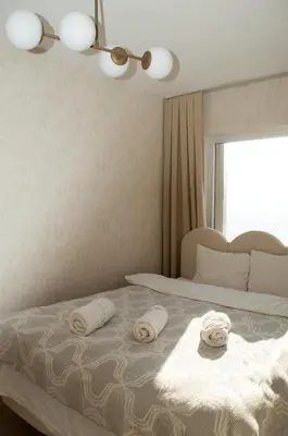 a bedroom with a bed with two towels on it at Luxe Suite AY37 in Eskiömerler