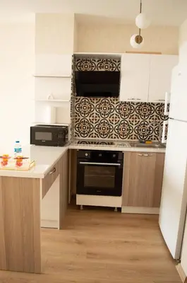 a kitchen with a stove and a microwave at Luxe Suite AY37 in Eskiömerler