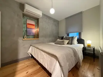 a bedroom with a bed and a painting on the wall at Stunning Private House in Balat in Istanbul