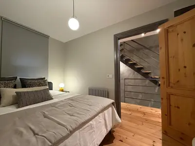 a bedroom with a large bed and a staircase at Stunning Private House in Balat in Istanbul