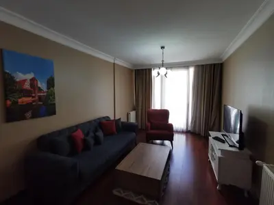 a living room with a blue couch and a chair at CTS Elysium Residence Taksim in Istanbul