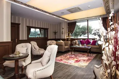 a living room with white chairs and a table at Le Marde Hotel in Istanbul