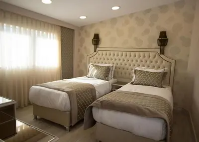 a hotel room with two beds and a window at Le Marde Hotel in Istanbul