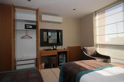 a bedroom with a bed and a tv and a chair at Le Marde Hotel in Istanbul
