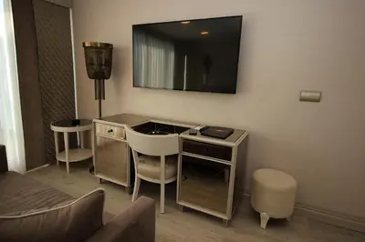 a room with a desk with a television on the wall at Le Marde Hotel in Istanbul