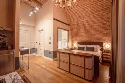 a bedroom with a bed and a brick wall at Stone Inn Galata in Istanbul