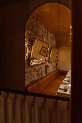 a row of tables in a restaurant with a stone wall at Stone Inn Galata in Istanbul