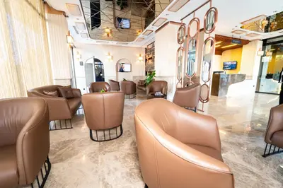 a waiting room with brown chairs and tables at Educity Hotels & Spa in Istanbul