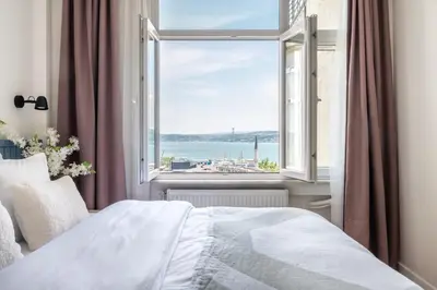 a bedroom with a window with a view of the water at Stay Beyond the Bosphorus #6 in Istanbul