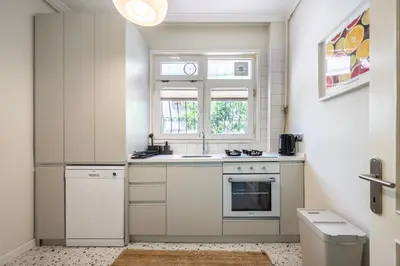 a white kitchen with a sink and a window at Stay Beyond the Bosphorus #6 in Istanbul