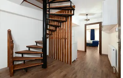 a spiral staircase in a room with a bedroom at Historical Wood Dublex Apt at Taksim&Galata in Istanbul