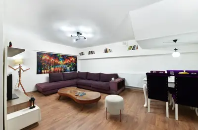 a living room with a purple couch and a table at Historical Wood Dublex Apt at Taksim&Galata in Istanbul