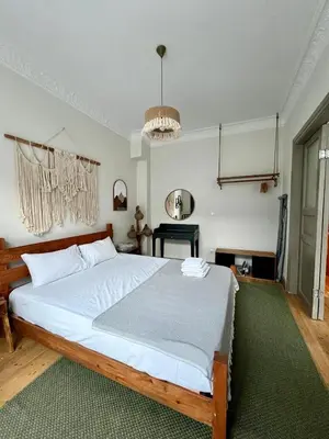 a bedroom with a large white bed in a room at Old Town Loft in Balat in Istanbul