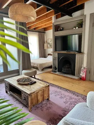 a living room with a fireplace and a tv at Old Town Loft in Balat in Istanbul