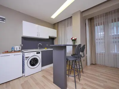 a kitchen with a washing machine and a counter at Blueway in Istanbul