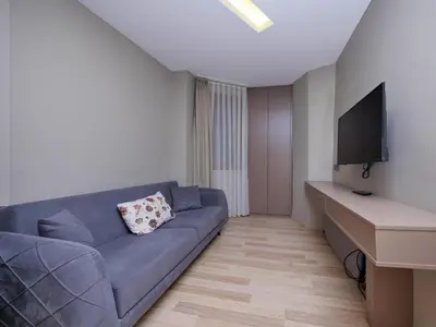a living room with a blue couch and a flat screen tv at Blueway in Istanbul