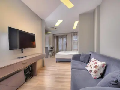 a living room with a couch and a flat screen tv at Blueway in Istanbul