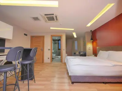 a bedroom with a bed and a desk and chairs at Blueway in Istanbul