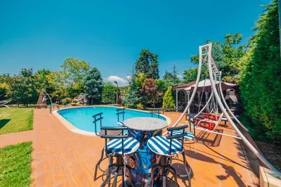 a playground with a table and chairs next to a pool at Sapancada ısıtmalı havuzlu villa in Sapanca