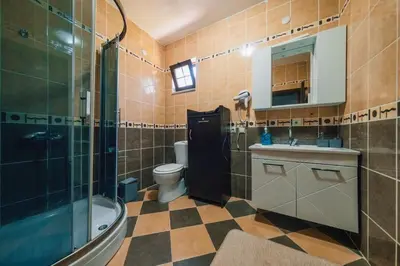 a bathroom with a shower and a toilet and a sink at Sapancada ısıtmalı havuzlu villa in Sapanca