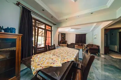 a dining room with a table and a living room at Sapancada ısıtmalı havuzlu villa in Sapanca