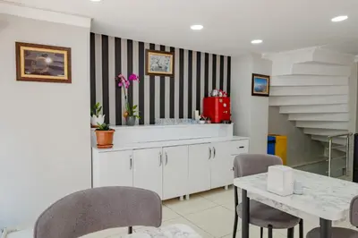 a kitchen with a table and chairs and a staircase at JAMMY Hotel in Istanbul