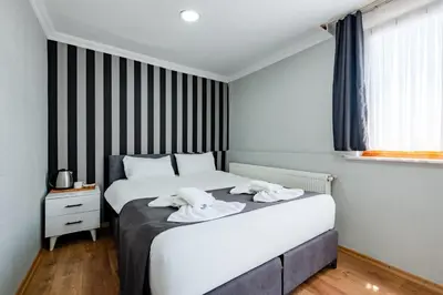 a bedroom with a bed with two towels on it at JAMMY Hotel in Istanbul
