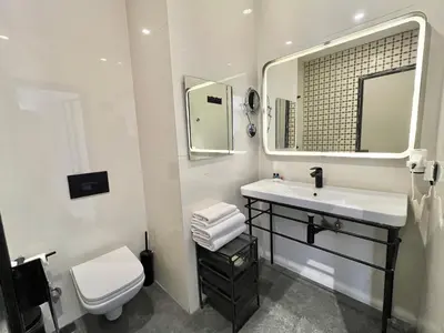 a bathroom with a sink and a toilet and a mirror at Fitas Oda Hotel in Istanbul