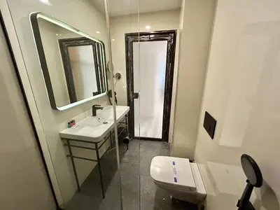 a bathroom with a sink and a toilet and a mirror at Fitas Oda Hotel in Istanbul