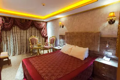 a hotel room with a bed and a table and chairs at Grand Ambiance Hotel in Istanbul