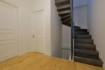 a staircase in a room with white walls and wooden floors at Casa Isabel - Amazing 5Br House in Prime Location in Istanbul