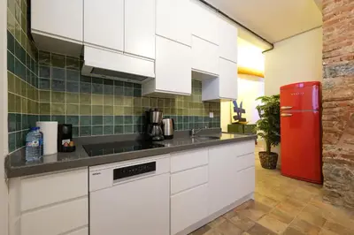a kitchen with white cabinets and a red refrigerator at Casa Isabel - Amazing 5Br House in Prime Location in Istanbul