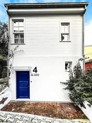 a white house with a blue door at Rent the Entire Bosphorus House in Istanbul