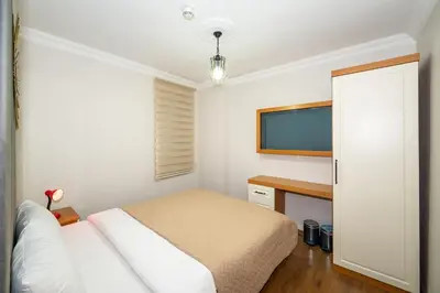 a bedroom with a bed and a flat screen tv at Aras Life Hotel in Istanbul