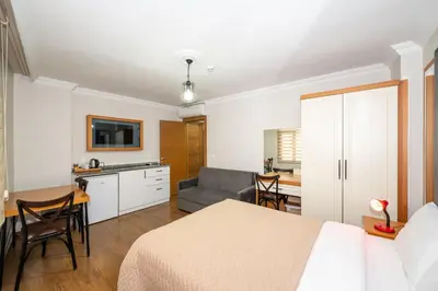 a bedroom with a bed and a kitchen and a couch at Aras Life Hotel in Istanbul