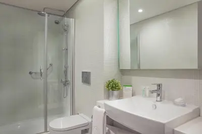a bathroom with a sink and a toilet and a shower at Burgu Arjaan by Rotana Istanbul Asia in Istanbul